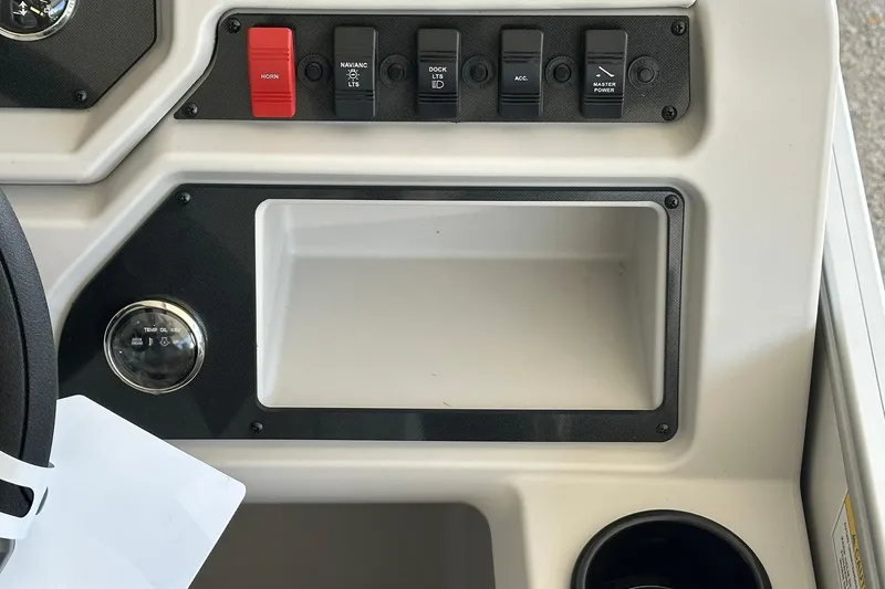 Slide: The Image of Control panel of 2026 Sweetwater EX2286SBX boat with switches and storage compartment. - 15