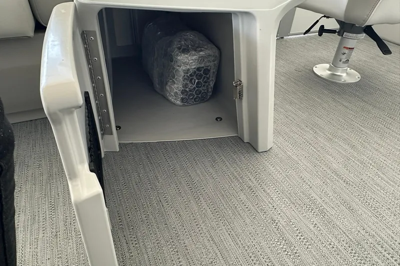 Slide: The Image of Storage compartment in 2026 Sweetwater EX2286SBX boat with bubble-wrapped item inside. - 18