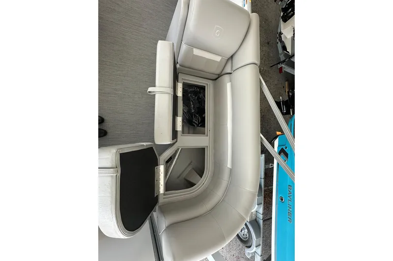 Slide: The Image of Sweetwater EX2286SBX 2026 boat interior with gray seating and storage compartment. - 6