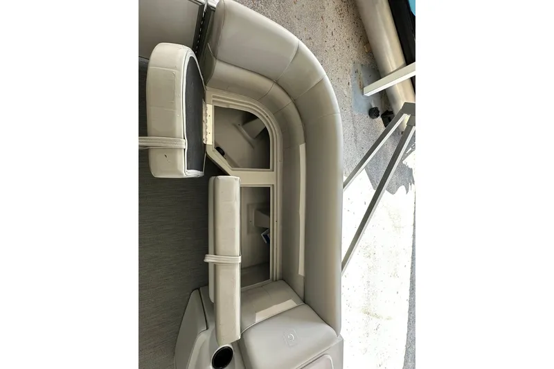 Slide: The Image of 2026 Sweetwater EX2286SBX pontoon boat interior with beige seating and storage compartments. - 8