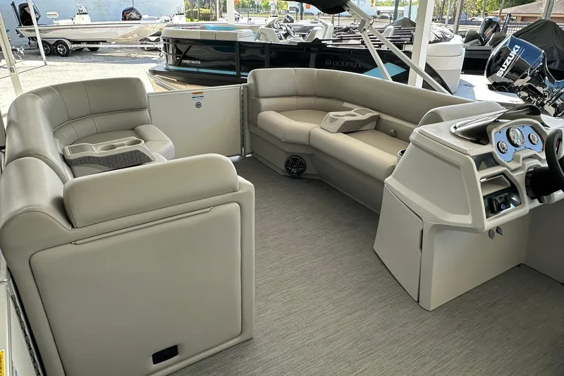 Slide: The Image of Interior of 2026 Sweetwater EX2286SBX pontoon boat with plush seating and modern dashboard. - 9