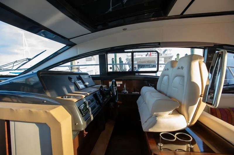 Slide: The Image of 2018 Sea Ray Sundancer 400 helm with luxurious seating and modern controls. - 10