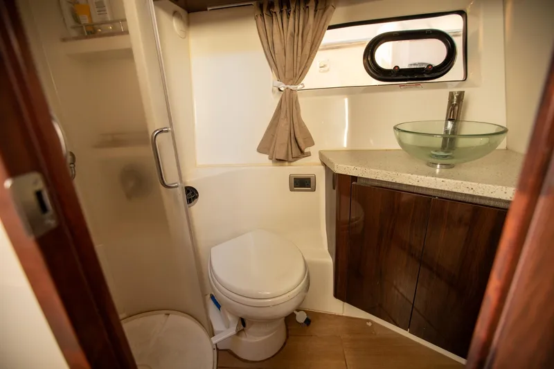 Slide: The Image of 2018 Sea Ray Sundancer 400 bathroom with modern fixtures and glass sink. - 18