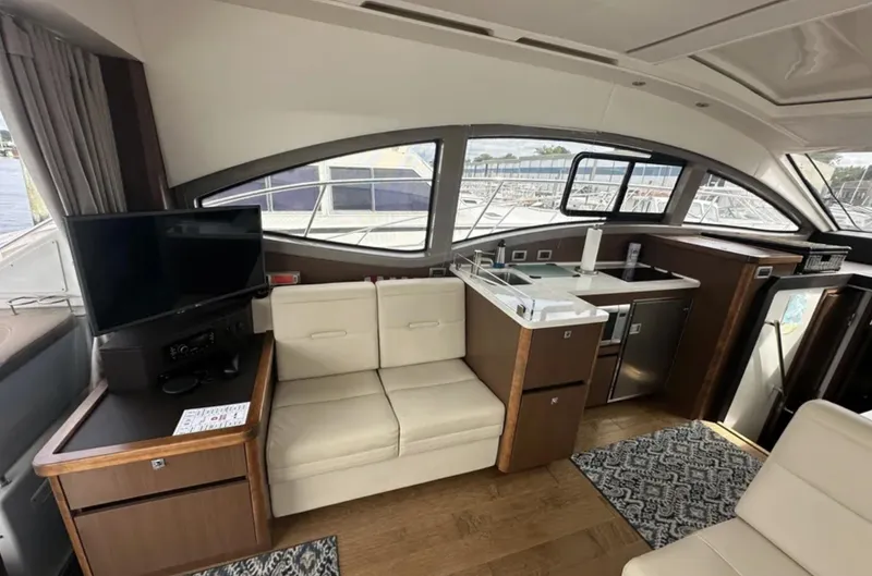 Slide: The Image of Interior of 2018 Sea Ray Sundancer 400 yacht with modern seating and kitchenette. - 5
