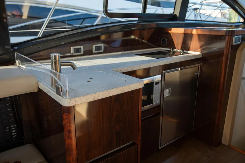 Slide: The Image of Luxurious 2018 Sea Ray Sundancer 400 yacht interior kitchen with modern appliances and sleek design. - 7