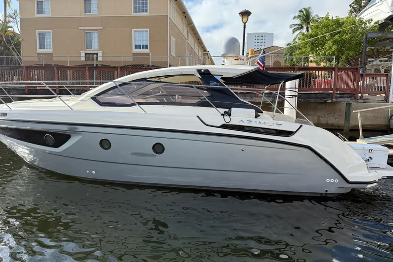 The Image of 2014 Azimut Atlantis 34 yacht docked by waterfront buildings. - 0