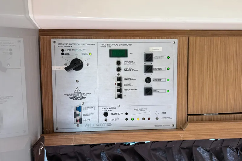 Slide: The Image of Electrical switchboard on 2014 Azimut Atlantis 34 yacht, featuring various control switches. - 13