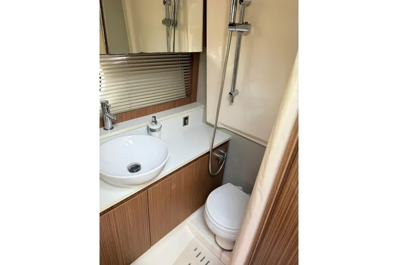 Slide: The Image of Luxurious bathroom in 2014 Azimut Atlantis 34 yacht with modern fixtures and wood accents. - 14