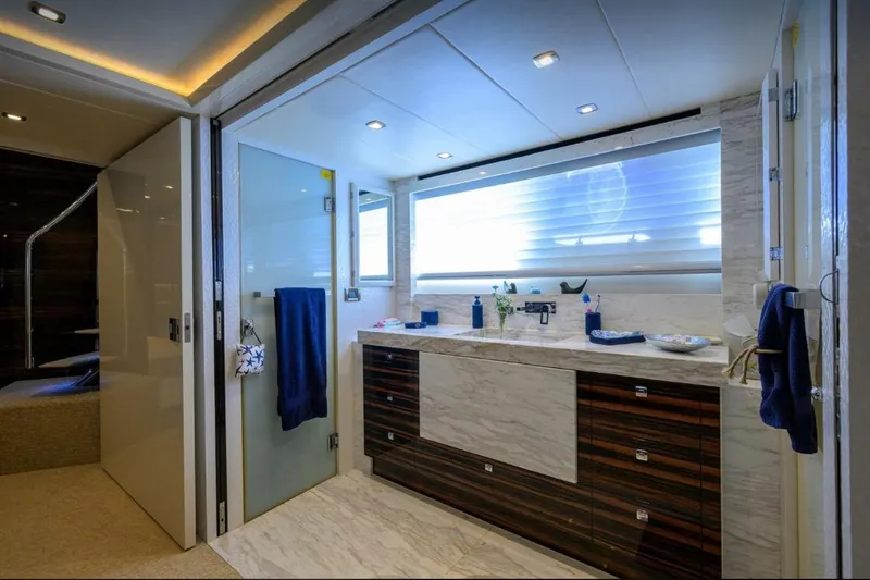 Slide: The Image of Luxurious yacht bathroom with modern fixtures, marble countertop, and ambient lighting, Hampton Fly 2014 model. - 20