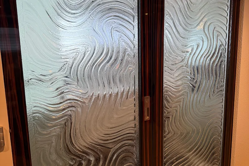 Slide: The Image of Textured glass door with wavy patterns, featuring a wooden frame. - 21