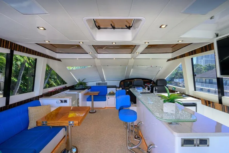 Slide: The Image of Luxurious interior of a 2014 Hampton Fly yacht with modern seating and panoramic windows. - 34