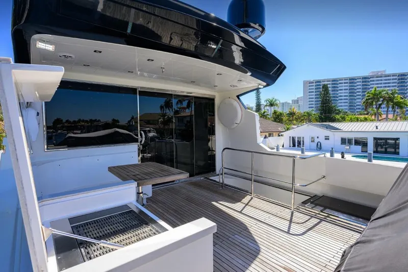 Slide: The Image of 2014 Hampton Fly yacht deck with modern design and cityscape view. - 37