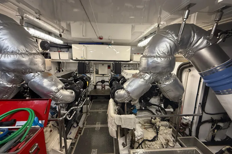 Slide: The Image of Engine room of a 2014 Hampton Fly yacht with insulated pipes and machinery. - 44