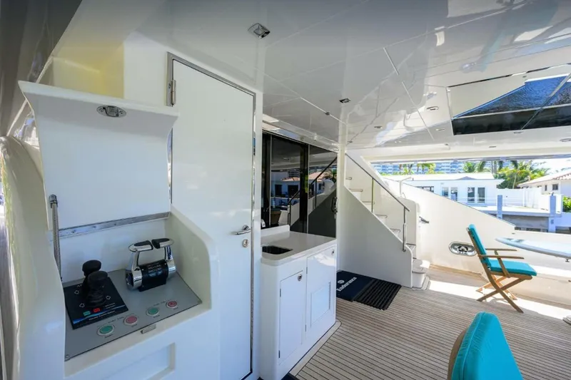 Slide: The Image of Luxurious 2014 Hampton Fly yacht interior with modern design and outdoor seating area. - 8