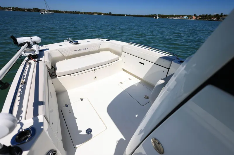 Slide: The Image of 2025 World Cat 235 TE boat interior with seating, on calm blue water. - 12