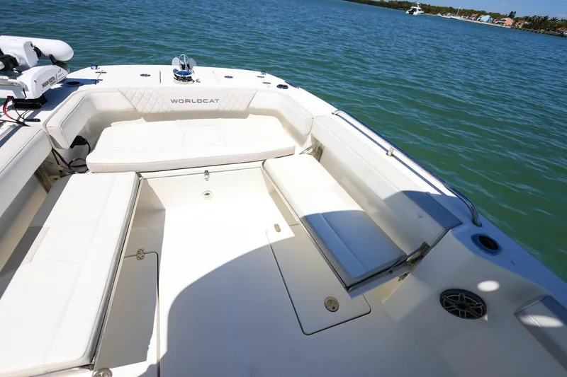 Slide: The Image of 2025 World Cat 235 TE boat interior with white seating, on calm water. - 13