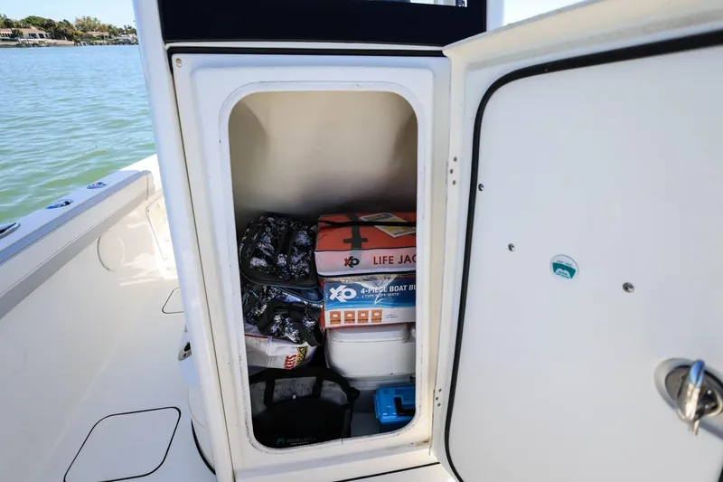 Slide: The Image of Storage compartment on 2025 World Cat 235 TE boat with life jackets and gear. - 18