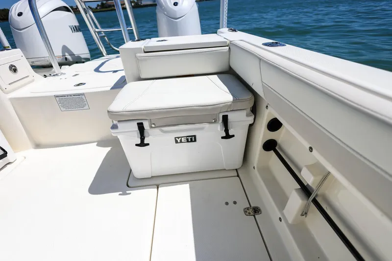 Slide: The Image of 2025 World Cat 235 TE boat interior with Yeti cooler and Yamaha engines. - 22