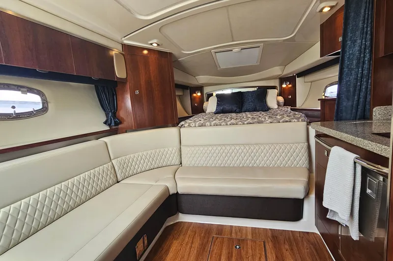 Slide: The Image of Luxurious interior of 2015 Chaparral 310 Signature yacht with elegant seating and cozy bed. - 26