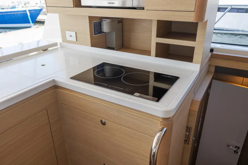 Slide: The Image of 2022 Aquila 44 Yacht docked at marina, showcasing sleek design and branding. - 11