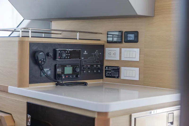 Slide: The Image of 2022 Aquila 44 Yacht docked with city skyline in background. - 13