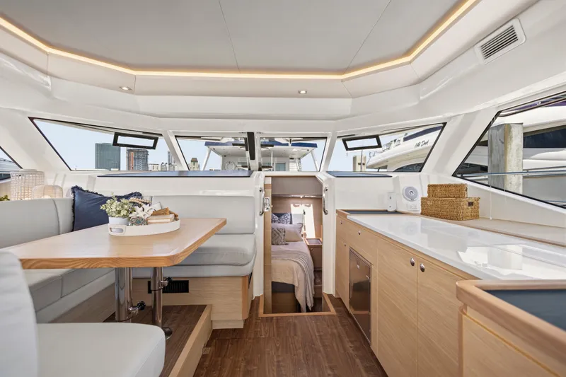 Slide: The Image of Aquila 44 Yacht 2022 model with elegant seating and table on deck. - 15