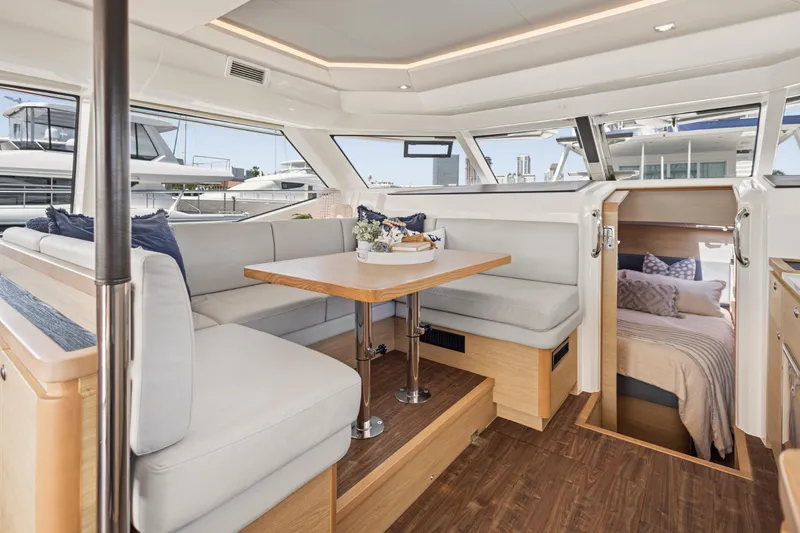 Slide: The Image of Interior view of 2022 Aquila 44 Yacht featuring modern bar stools and sleek cabinetry. - 16