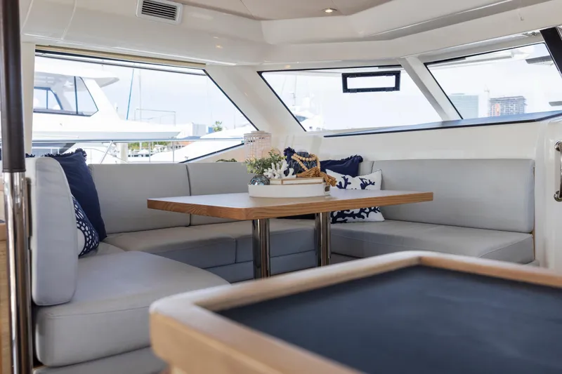Slide: The Image of Luxury bar stools on 2022 Aquila 44 Yacht deck, featuring sleek chrome and white design. - 17
