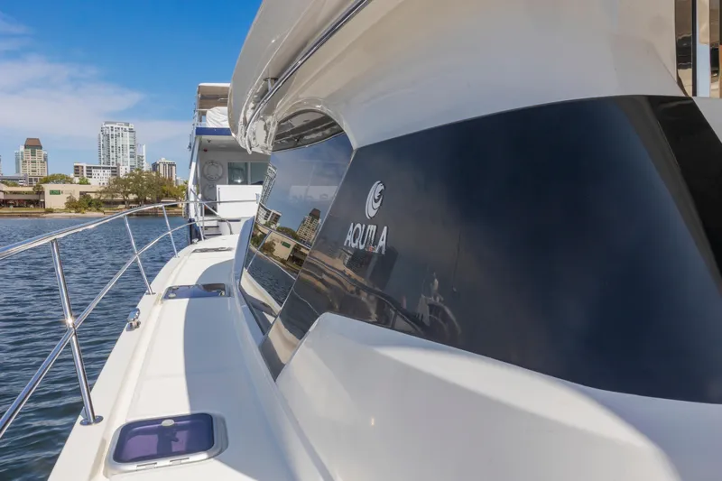 Slide: The Image of Aquila 44 Yacht 2022 cruising on open sea under clear blue sky. - 3