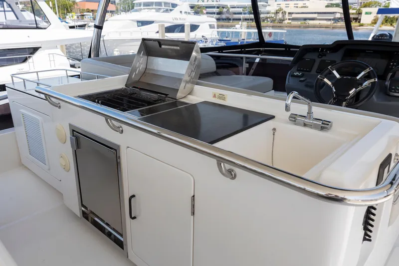 Slide: The Image of Shower area in 2022 Aquila 44 Yacht with chrome fixtures and white walls. - 43