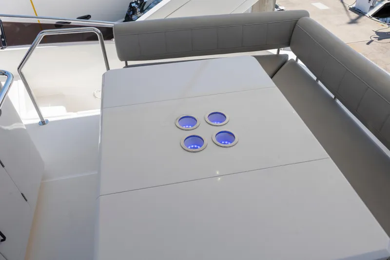 Slide: The Image of Cockpit of 2022 Aquila 44 Yacht with modern navigation controls and steering wheel. - 44