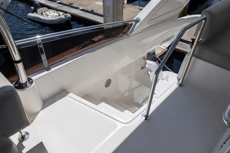Slide: The Image of Cockpit controls of 2022 Aquila 44 Yacht with navigation display and steering wheel. - 45