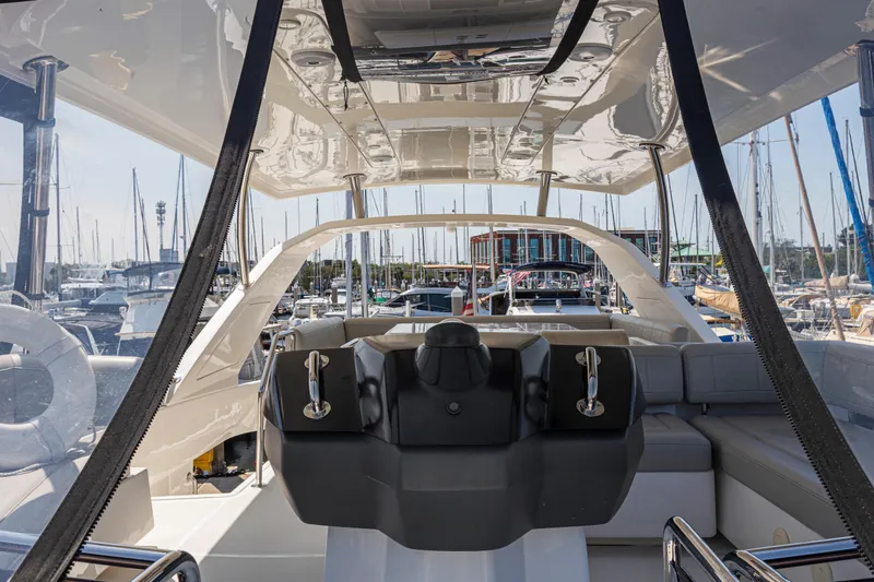 Slide: The Image of Interior view of 2022 Aquila 44 Yacht helm station with marina background. - 53