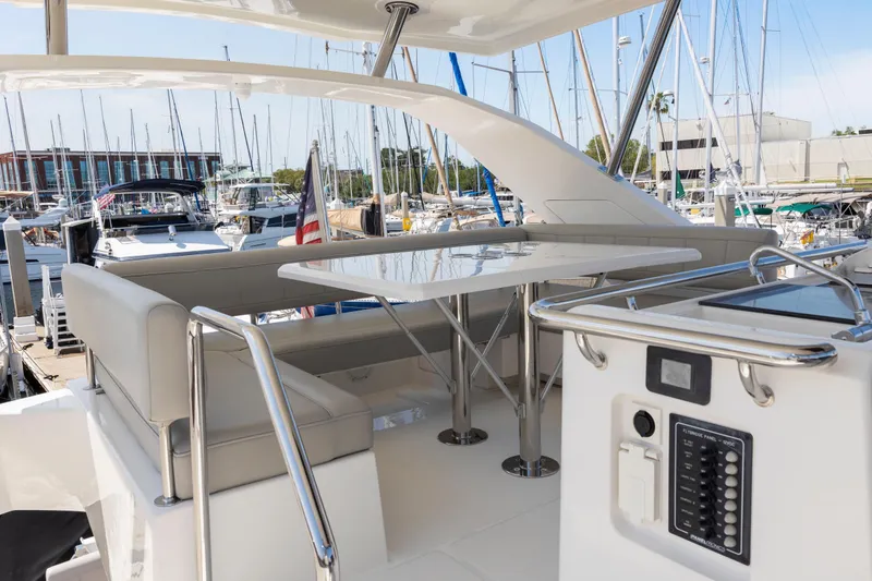 Slide: The Image of 2022 Aquila 44 Yacht interior with seating and control panel at marina. - 54