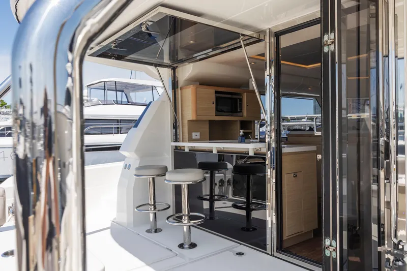 Slide: The Image of Aquila 44 Yacht 2022 cruising on open water, aerial rear view. - 6