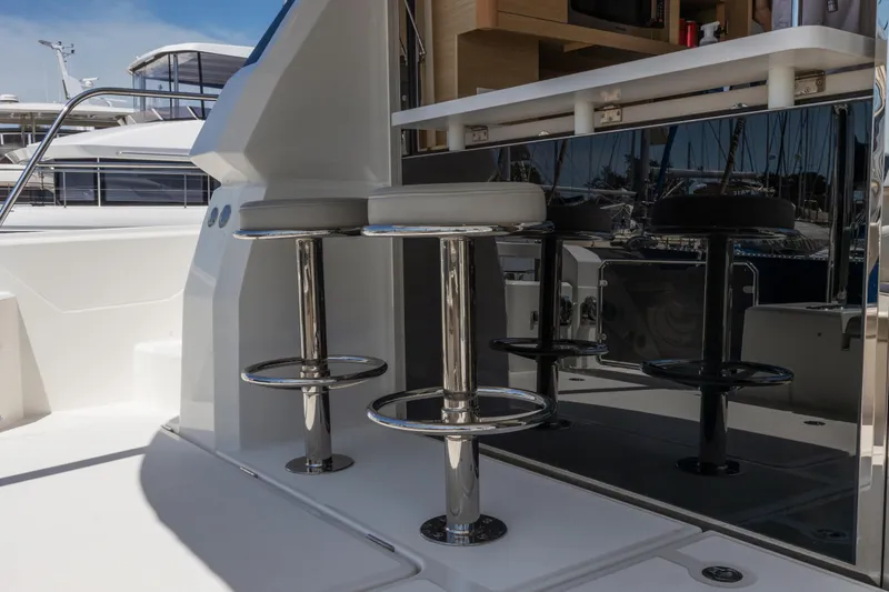 Slide: The Image of Aerial view of 2022 Aquila 44 Yacht cruising on clear green water. - 7