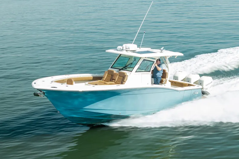 The Image of 2020 Scout 355 LXF boat cruising on open water, showcasing sleek design and powerful engines. - 0