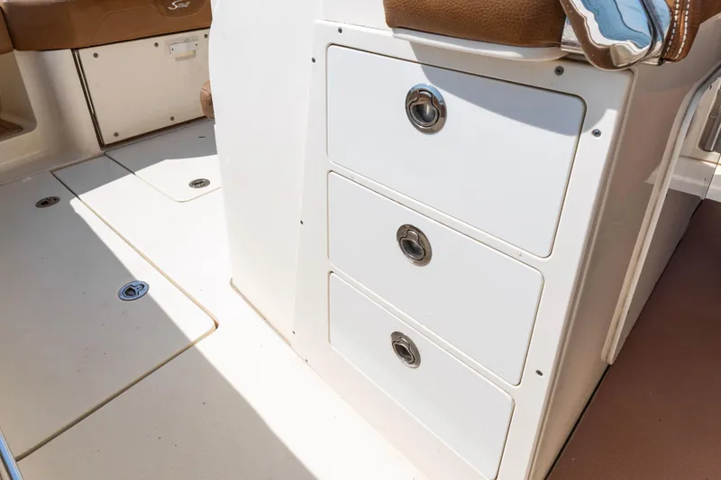 Slide: The Image of 2020 Scout 355 LXF boat interior with storage drawers and seating. - 13