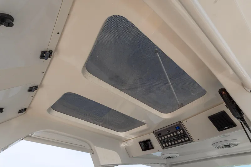 Slide: The Image of 2020 Scout 355 LXF boat interior ceiling with control panel and ventilation. - 20