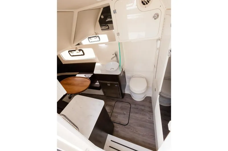 Slide: The Image of Manufacturer Provided Image: 2020 Scout 355 LXF boat interior with bathroom, sink, and seating area. - 22