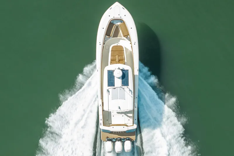 Slide: The Image of Aerial view of 2020 Scout 355 LXF boat cruising on water. - 6