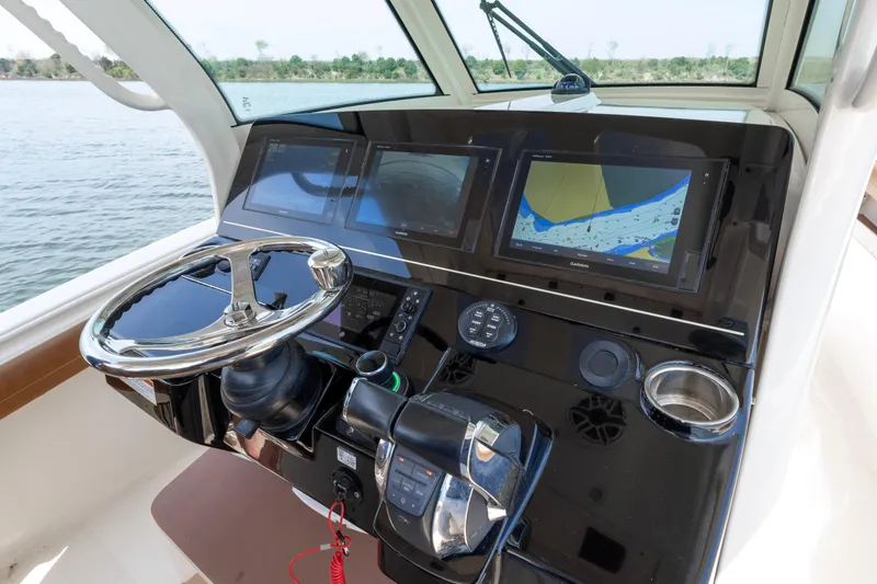 Slide: The Image of Control panel of 2020 Scout 355 LXF boat with navigation screens and steering wheel. - 7