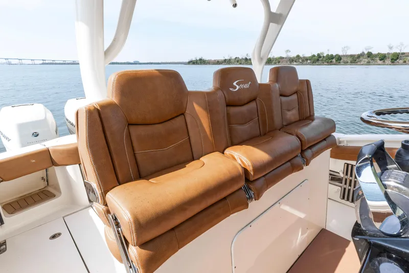 Slide: The Image of Luxurious leather seating on 2020 Scout 355 LXF boat, overlooking serene waters. - 8