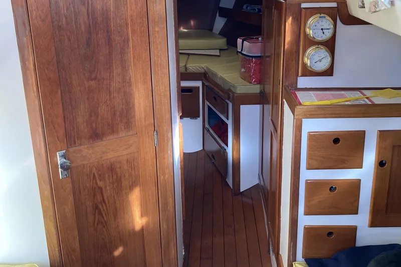 Slide: The Image of Interior of a 1971 Luders 33 sailboat with wooden cabinetry and nautical instruments. - 10