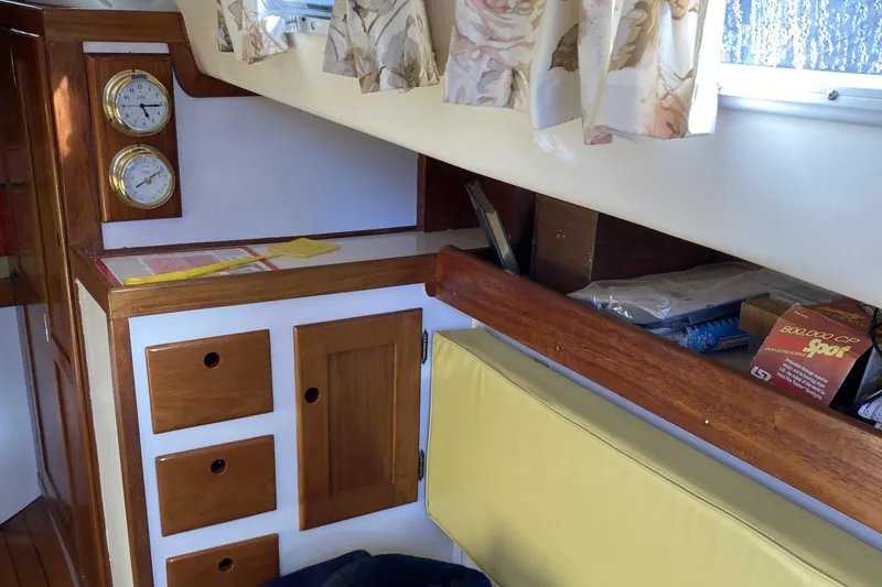 Slide: The Image of Interior of a 1971 Luders 33 sailboat with wooden cabinetry and nautical instruments. - 11