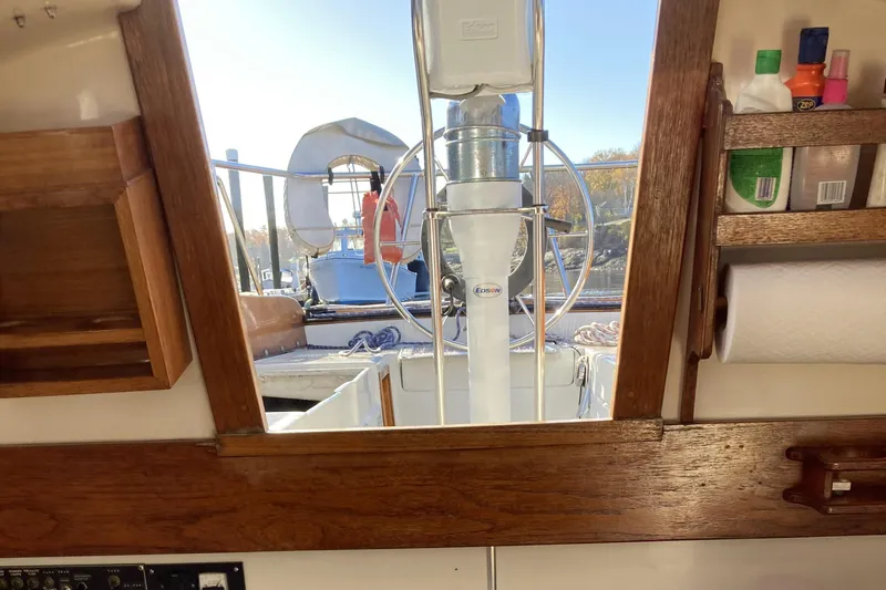 Slide: The Image of Interior view of a 1971 Luders 33 sailboat, showcasing wooden cabinetry and cockpit. - 12