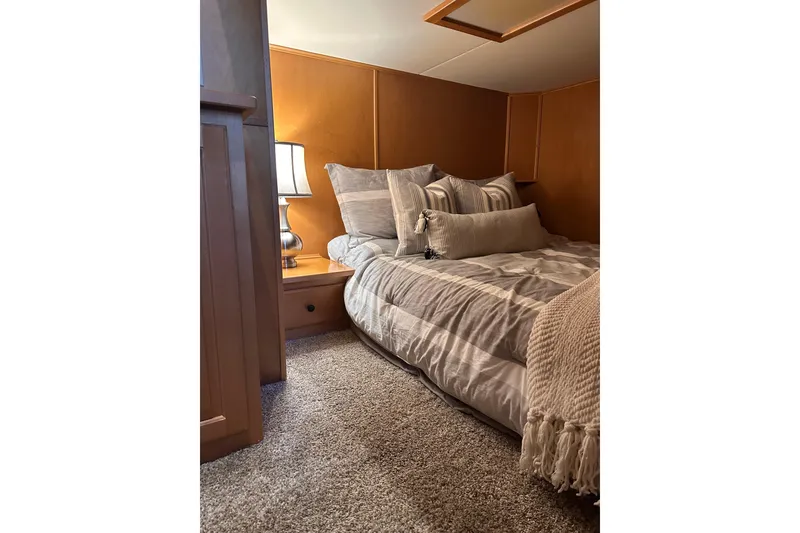 Slide: The Image of Cozy bedroom in 2008 Starlite 18x85 houseboat with plush bedding and warm lighting. - 10