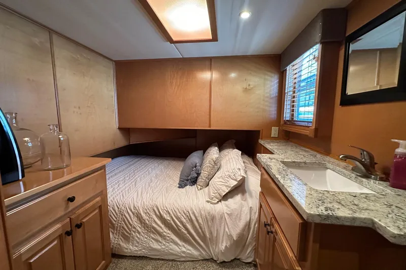 Slide: The Image of Cozy bedroom in 2008 Starlite 18x85 houseboat with wooden cabinetry and granite countertop. - 11