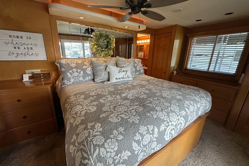 Slide: The Image of Cozy bedroom in 2008 Starlite 18x85 houseboat with floral bedding and decorative pillows. - 13