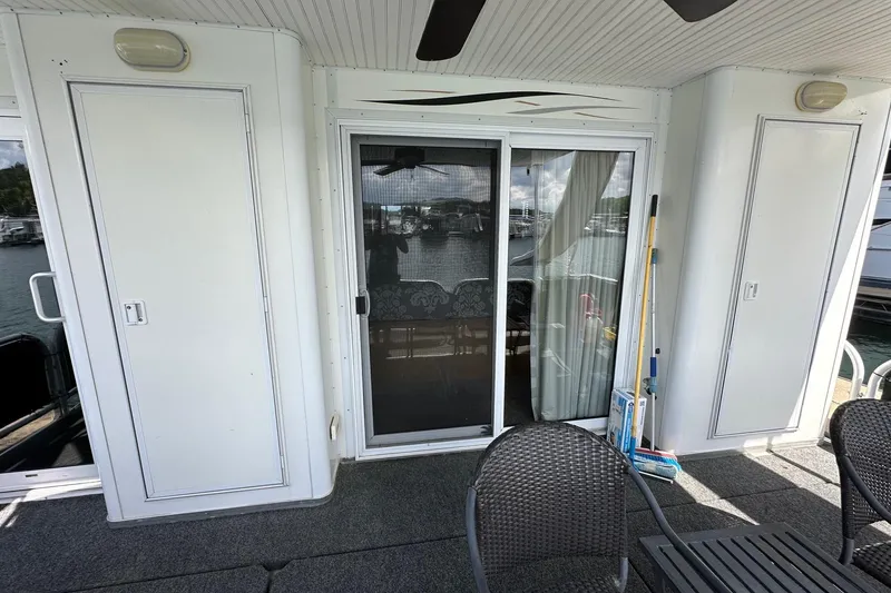 Slide: The Image of Houseboat deck with sliding glass door, chairs, and storage cabinets, Starlite 18x85, 2008 model. - 17